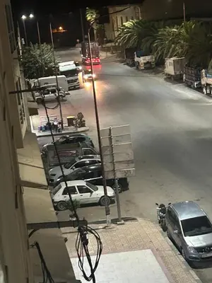 a view of a street with cars parked on the road at Très bel appartement spacieux in Taza