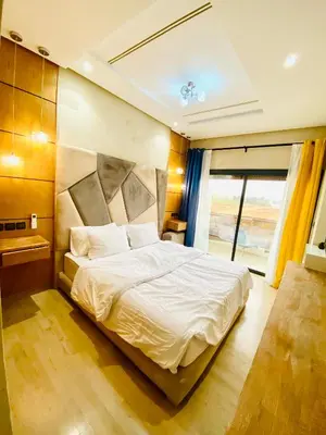 a bedroom with a bed and a large window at New dream home in Fès