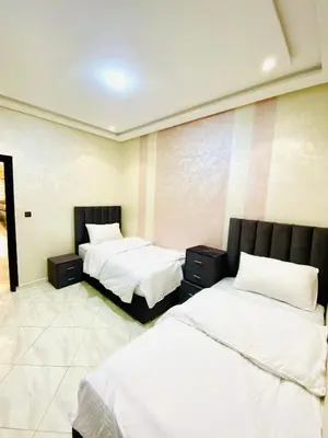 two beds in a room with white sheets at New dream home in Fès