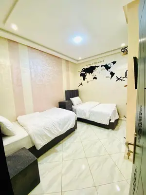 a room with two beds and a map on the wall at New dream home in Fès