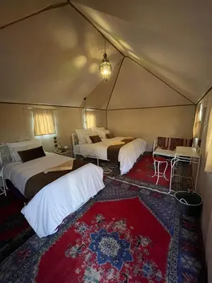 a bedroom with two beds in a tent at Desert tours&trips in Zagora