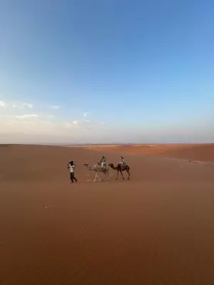 three people riding horses in the desert at Desert tours&trips in Zagora