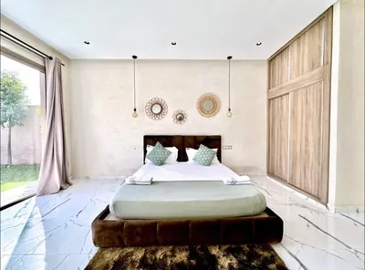 a bedroom with a large bed and a large window at Villa shams Marrakech , Private Pool and Hammam in Azib Oulad Lâdem