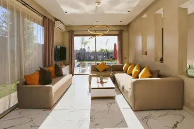 a living room with two couches and a large window at Villa shams Marrakech , Private Pool and Hammam in Azib Oulad Lâdem