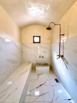 a bathroom with a white marble floor and a lamp at Villa shams Marrakech , Private Pool and Hammam in Azib Oulad Lâdem