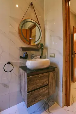 a bathroom with a sink and a mirror at Villa shams Marrakech , Private Pool and Hammam in Azib Oulad Lâdem