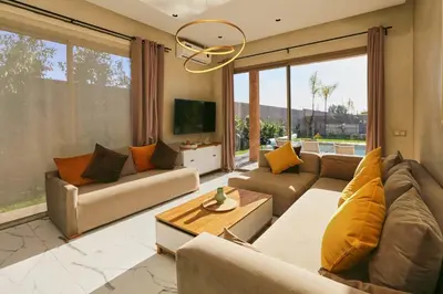 a large living room with couches and a tv at Villa shams Marrakech , Private Pool and Hammam in Azib Oulad Lâdem