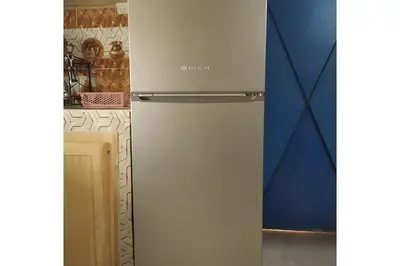 a refrigerator in a kitchen next to a wall at Desert house in Merzouga