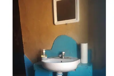a bathroom with a sink and a mirror at Desert house in Merzouga