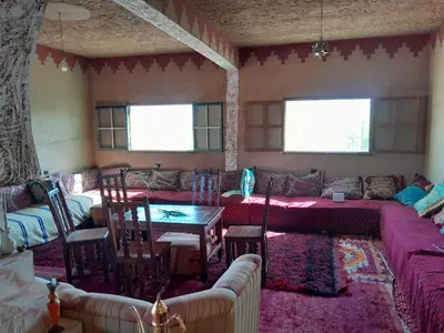 a living room with a couch and a table at Auberge chez hammadi