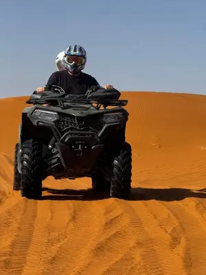 a person riding a quad bike in the desert at Nights luxury camp in Merzouga