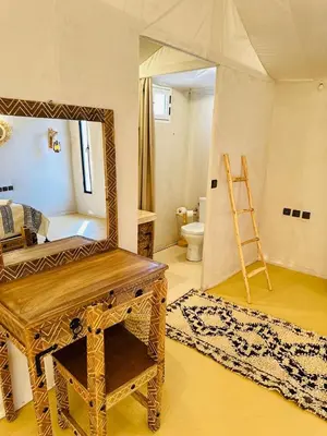 a room with a mirror and a bathroom with a toilet at Nights luxury camp in Merzouga
