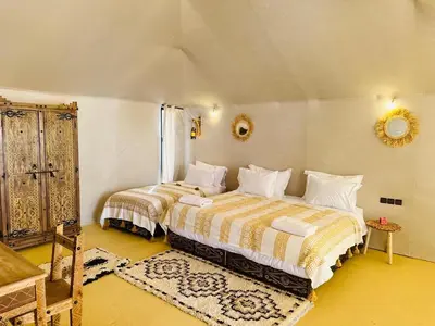 a bedroom with two beds in a room at Nights luxury camp in Merzouga