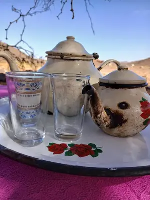 a tea pot and glasses on a table at Agoudim Nikhartan in Tinerhir