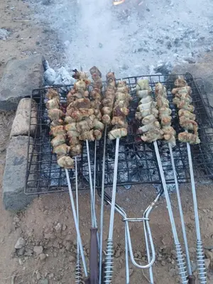 a bunch of food cooking on a grill at Agoudim Nikhartan in Tinerhir