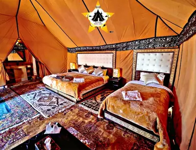 a bedroom with two beds in a tent at Merzouga Stellar Camp in Merzouga