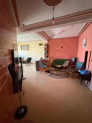 a living room with a couch and chairs at Apparemment à 100 mètres du complexe de fes in Fès