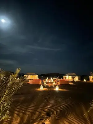 a group of vehicles parked in a desert at night at Connect Nomad - Luxury Camp Merzouga in Merzouga