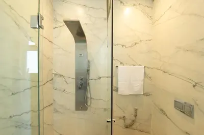 a shower with a glass door in a bathroom at Villa Dar E'Zwinna in Marrakech