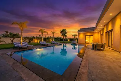 a swimming pool in the middle of a house at Villa Dar E'Zwinna in Marrakech