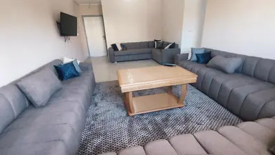 a living room with couches and a coffee table at Bright & Calm Apartment in Riad Toulal in Meknès