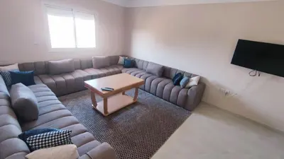 a living room with a couch and a table at Bright & Calm Apartment in Riad Toulal in Meknès