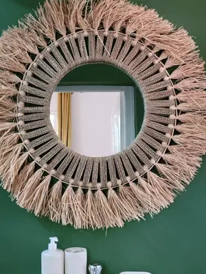 a large wicker mirror hanging on a green wall at Green Ourika Haven Relax Among Mountains Nature