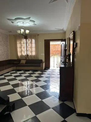 a living room with a checkered floor and a couch at la perle de fes in Fès