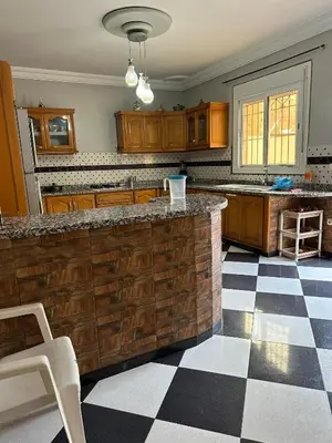 a kitchen with a counter and a checkered floor at la perle de fes in Fès
