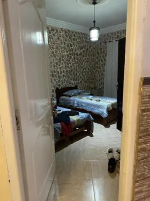 a room with two beds and a door open at la perle de fes in Fès