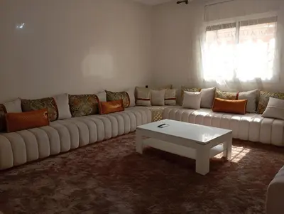 a living room with a white couch and a coffee table at URBAN WHITE Oasis 2 in Beni Mellal