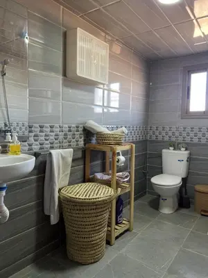 a bathroom with a toilet and a sink at Oasis apartment in Ouarzazate