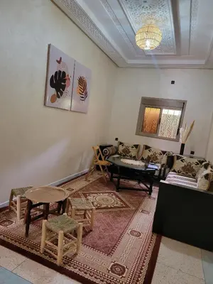 a living room with a couch and a table at Oasis apartment in Ouarzazate