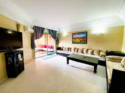 a large living room with a couch and a tv at Appartement d'orient centre ville in Oulad Akkou