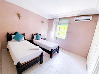 a room with two beds and a window at Appartement d'orient centre ville in Oulad Akkou