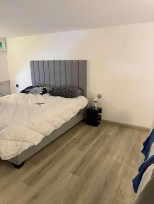 a bedroom with a large bed and a wooden floor at la bella cita fes in Fès