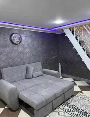 a living room with a couch and a staircase at la bella cita fes in Fès