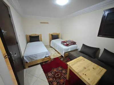 a small room with two beds and a couch at Gite les pommiers de tizi in Beni Mellal