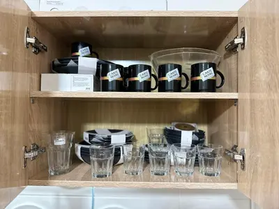a cupboard filled with cups and plates and glasses at Appartement centre errachidia in Er Rachidia
