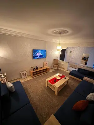 a living room with a couch and a coffee table at Appartement centre errachidia in Er Rachidia