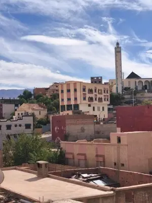 a view of a city with a tall building at maison de tourisme el amal in Oulad Akkou