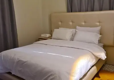a bed with white sheets and pillows in a bedroom at hotel and restaurant kasbah draa in Agdz