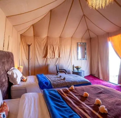 a bedroom with a bed in a tent at Merzouga Dream Starlight in Merzouga