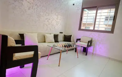 a living room with a couch and a table at URBAN WHITE Elya 1 in Beni Mellal