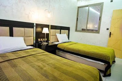 a hotel room with two beds and a mirror at URBAN WHITE Elya 1 in Beni Mellal