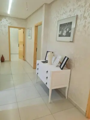 a room with a white desk with a picture on the wall at URBAN WHITE Elya 1 in Beni Mellal