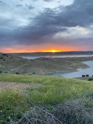 a sunset over a body of water in a field at Villa HMR ⵥ in El Ksiba