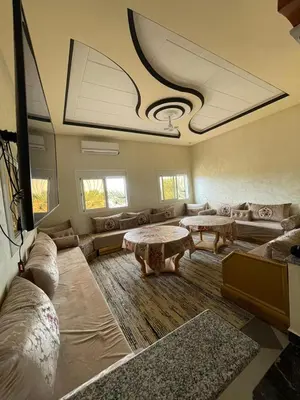 a large living room with couches and tables at Villa HMR ⵥ in El Ksiba