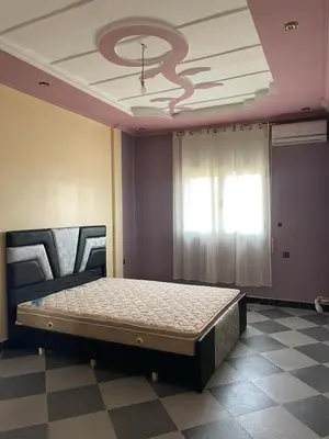 a bedroom with a bed in a room with a ceiling at Villa HMR ⵥ in El Ksiba