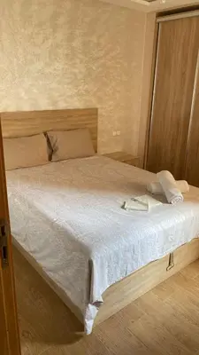 a bedroom with a large bed with white sheets at إقامة الرياض الأطلس in Beni Mellal